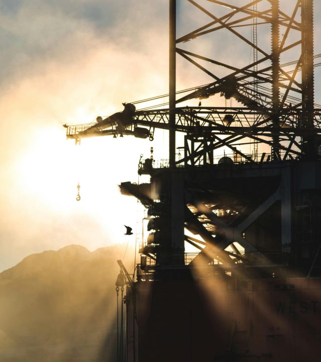 pexels-photo-1716008-1716008-2 Dramatic silhouette of industrial machinery against a foggy morning sunrise, capturing the essence of heavy industry.